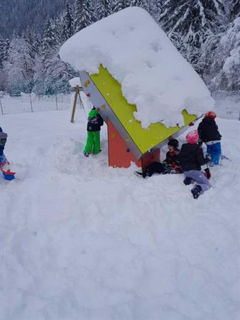Eine Gruppe von Kindern spielt in einem Schneemann